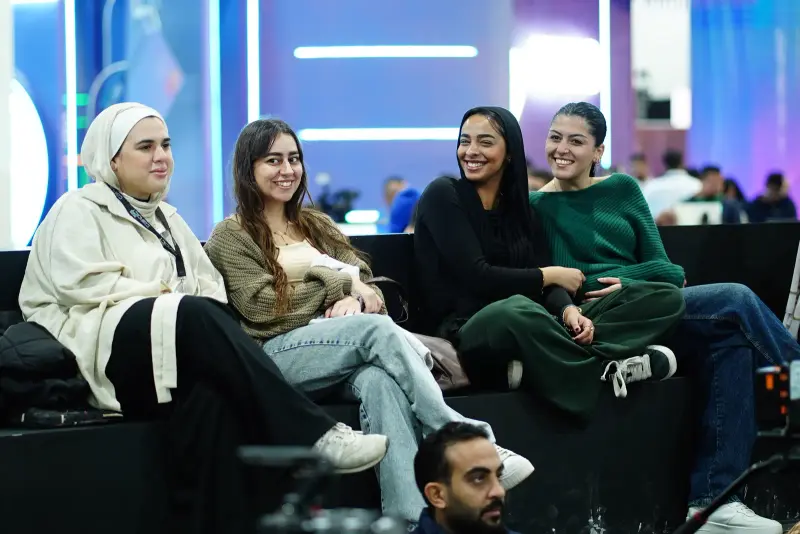 Smiling attendees enjoying a session on the AI Factory benches, Connecta 2025