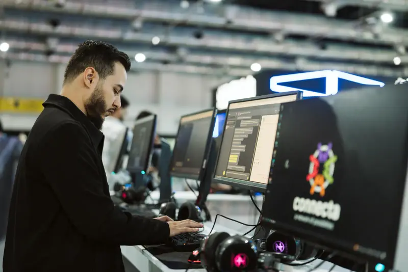 Developer working at a Connecta-branded PC in the AI Factory, Connecta 2025