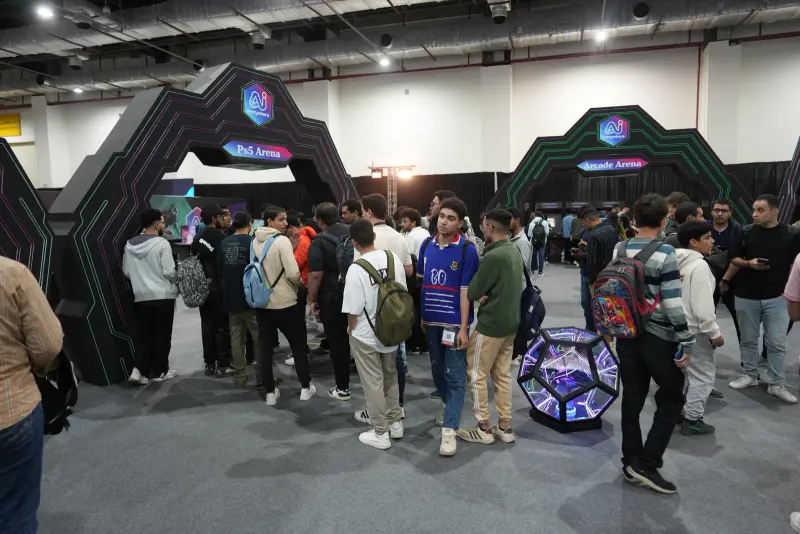 Young crowd at the arena gates beside a glowing LED installation, Connecta 2025