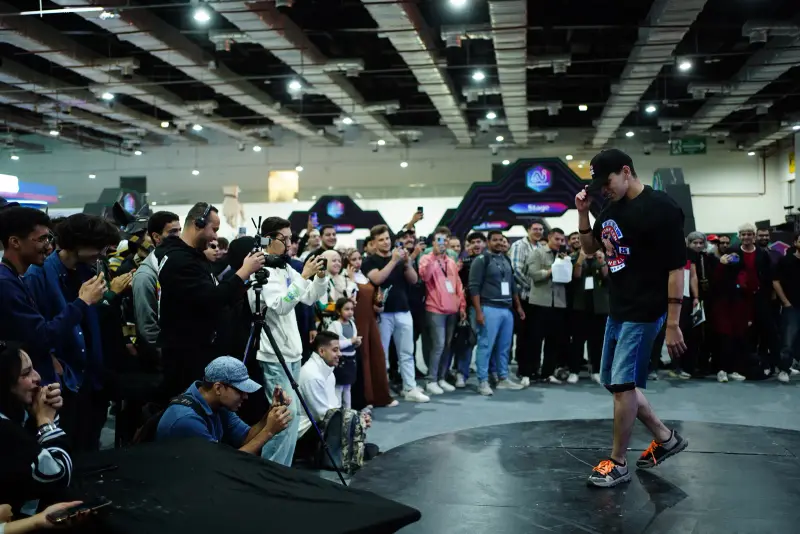 Spectators film a dance battle on the main floor, Connecta 2025