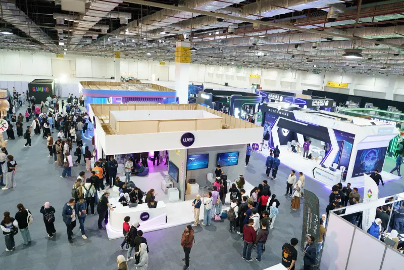 Aerial view of Hall 4 busy with visitors between colourful stands, Connecta 2025