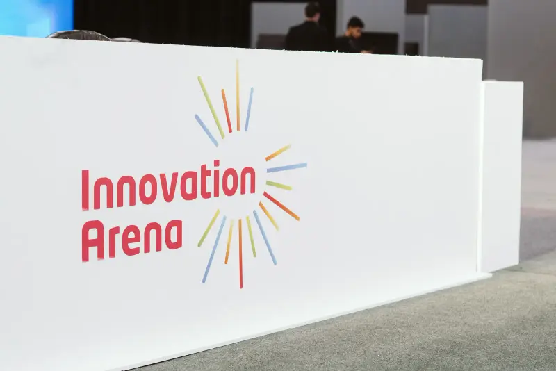 Innovation Arena sign with its colourful sunburst logo, Connecta 2025