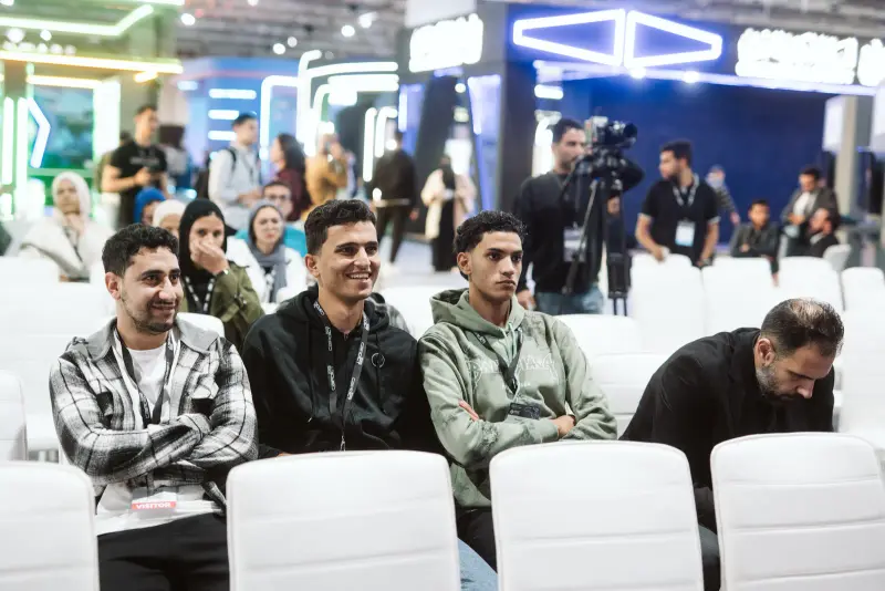 Smiling young attendees in the Innovation Arena seating, Connecta 2025