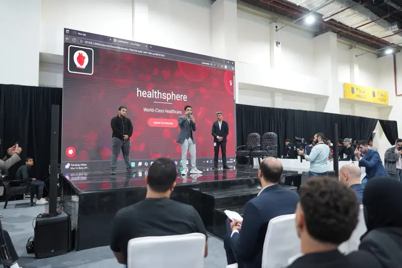 Team pitching a healthcare app on the arena stage before an audience, Connecta 2025