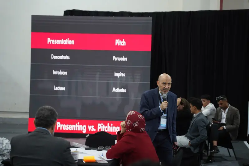 Trainer leading a Presenting vs Pitching workshop for seated teams, Connecta 2025