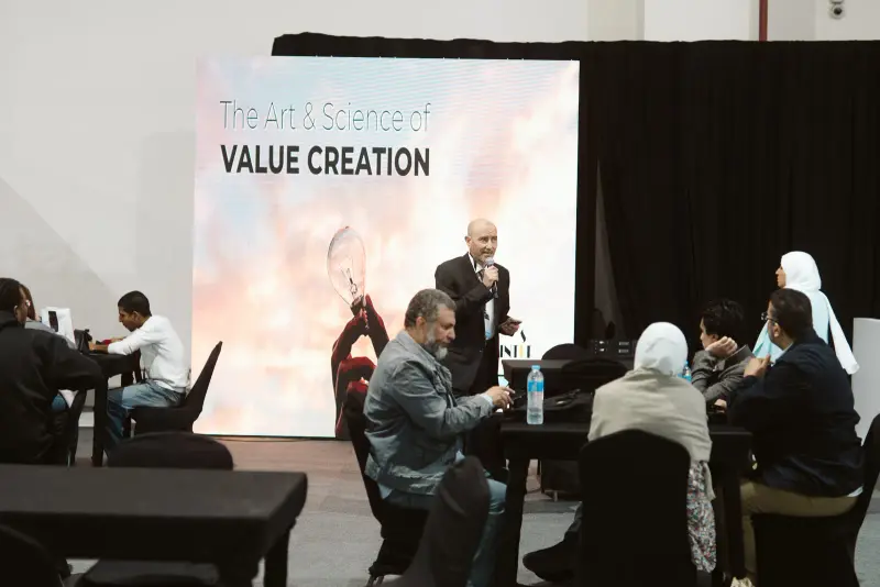 Value Creation workshop with participants gathered at round tables, Connecta 2025