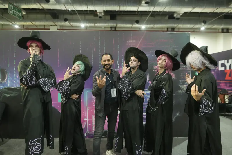 Group of witch cosplayers posing in front of the cyber backdrop, Connecta 2025