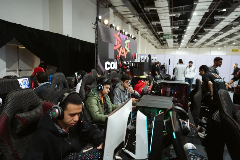 Rows of young gamers in headsets competing at PC stations, Connecta 2025